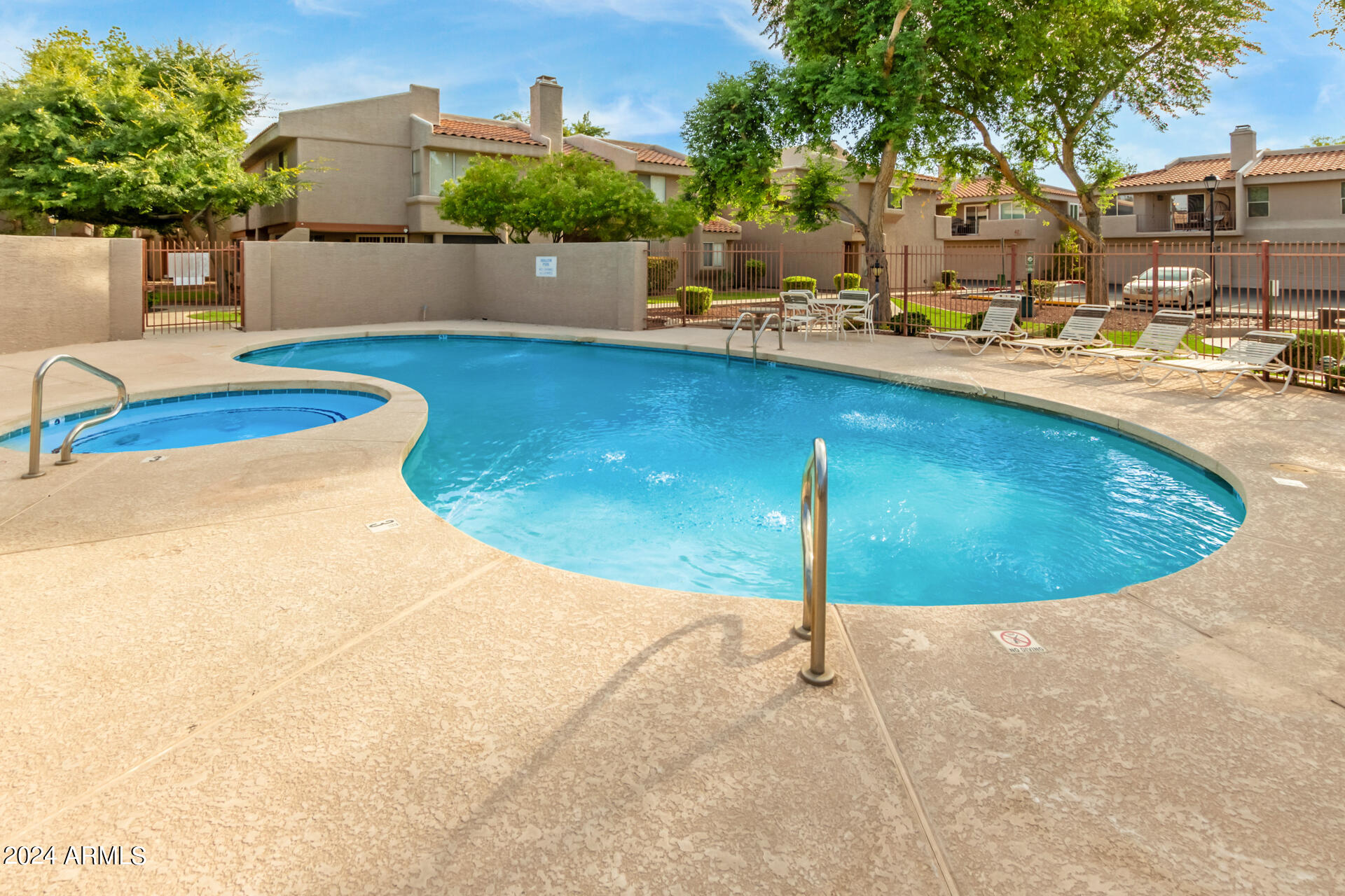 2834 South Ext Road, Unit 2058 Mesa, AZ 85210 - Photo 32 of 33 a view of a swimming pool with a patio