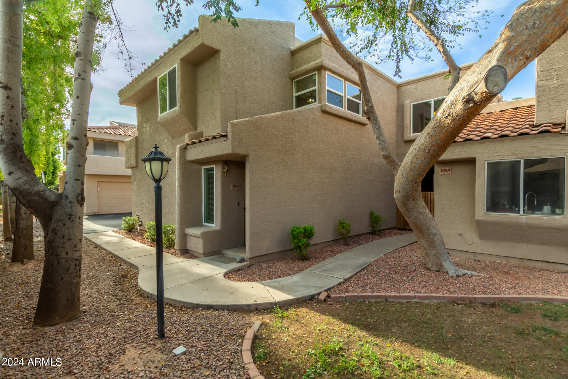2834 South Ext Road, Unit 2058 Mesa, AZ 85210 - Photo 8 of 33 a front view of a house with a yard