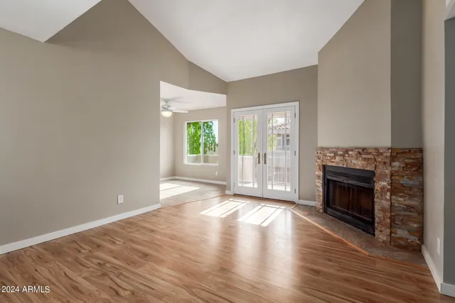 wooden floor fireplace and natural light in room