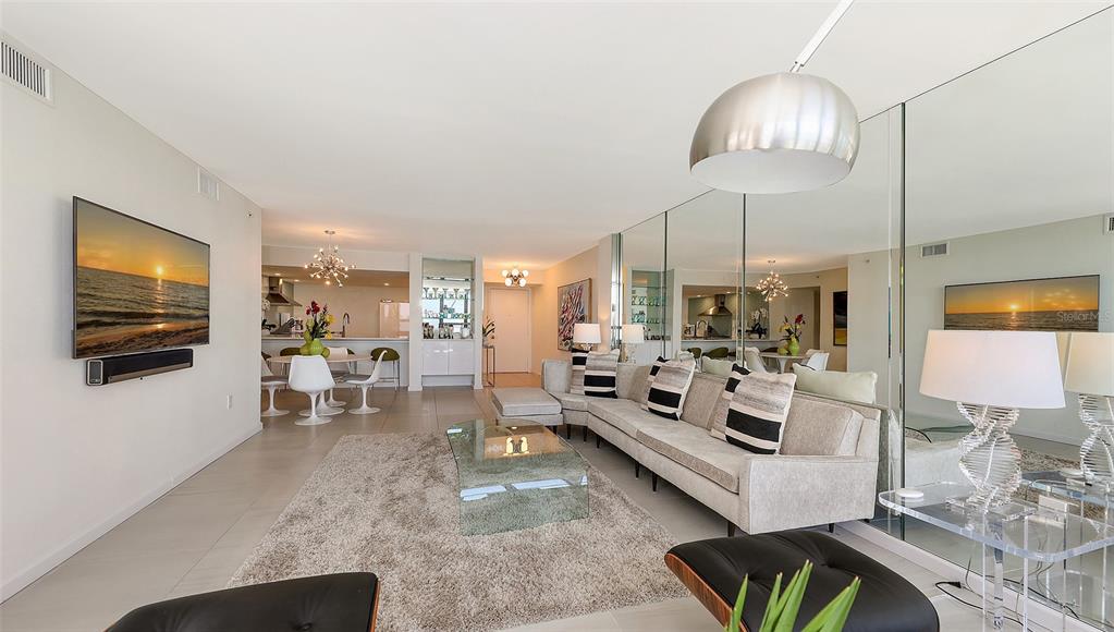 11 Sunset Drive, Unit 501 Sarasota, FL 34236 - Photo 12 of 63 a living room with furniture and a flat screen tv