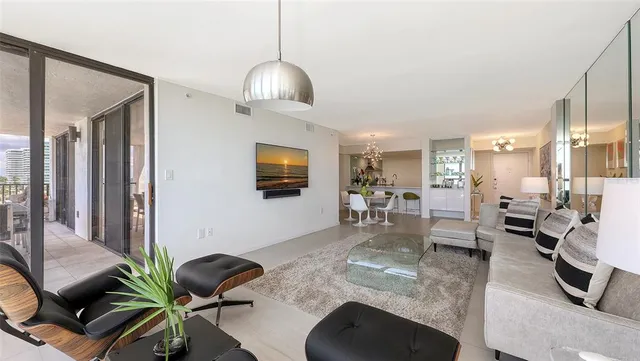 a dining room with furniture a livingroom and chandelier