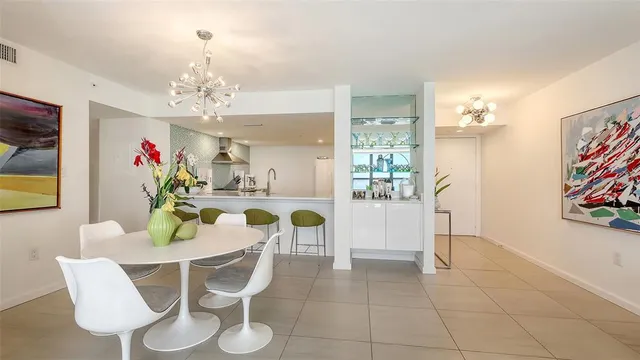 a spacious bathroom with a granite countertop sink a mirror and bathtub