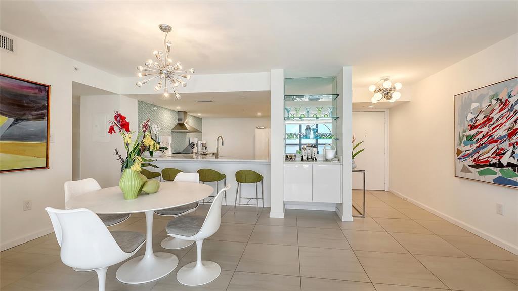 11 Sunset Drive, Unit 501 Sarasota, FL 34236 - Photo 14 of 63 a view of a dining room with furniture and chandelier