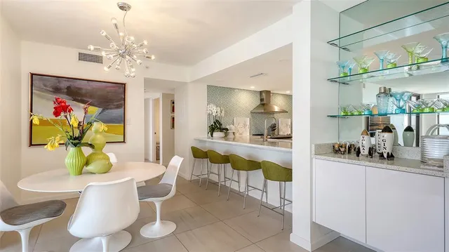 a dining room with furniture and a chandelier