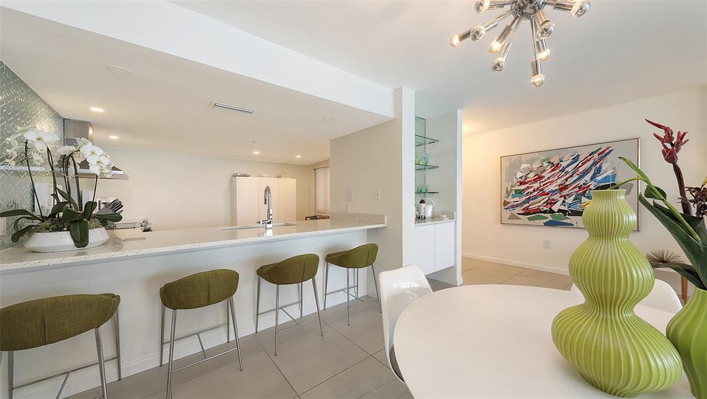 11 Sunset Drive, Unit 501 Sarasota, FL 34236 - Photo 16 of 63 a spacious bathroom with a granite countertop sink a mirror and bathtub