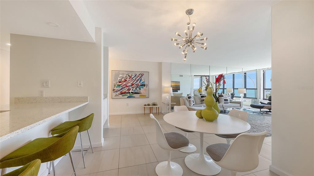 11 Sunset Drive, Unit 501 Sarasota, FL 34236 - Photo 17 of 63 a dining room with furniture and a chandelier