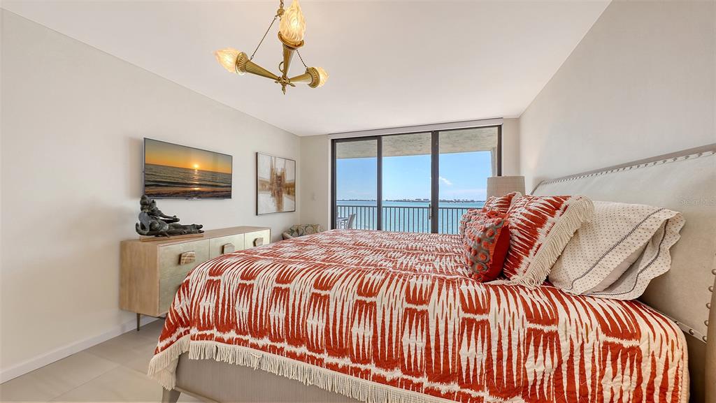 11 Sunset Drive, Unit 501 Sarasota, FL 34236 - Photo 24 of 63 a bedroom with a bed and a flat screen tv