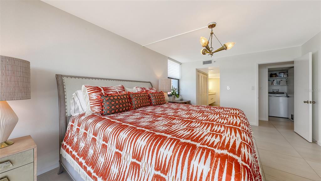 11 Sunset Drive, Unit 501 Sarasota, FL 34236 - Photo 26 of 63 a bedroom with a bed and wooden floor