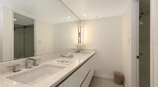 a bed sitting in a bedroom next to a large window