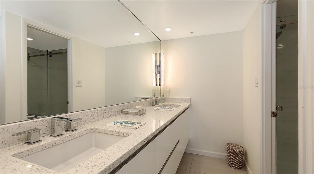 11 Sunset Drive, Unit 501 Sarasota, FL 34236 - Photo 27 of 63 a bathroom with a sink and a mirror