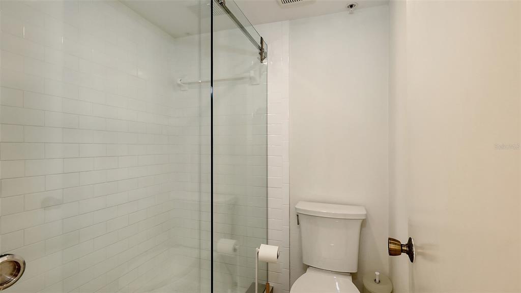 11 Sunset Drive, Unit 501 Sarasota, FL 34236 - Photo 28 of 63 a bathroom with a shower and a toilet