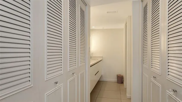 a bedroom with a bed and painting on the wall