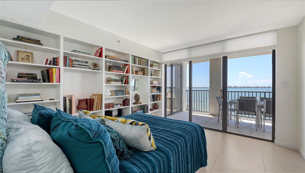 11 Sunset Drive, Unit 501 Sarasota, FL 34236 - Photo 30 of 63 a bed sitting in a bedroom next to a large window