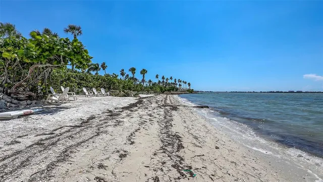a view of a blue house with a yard