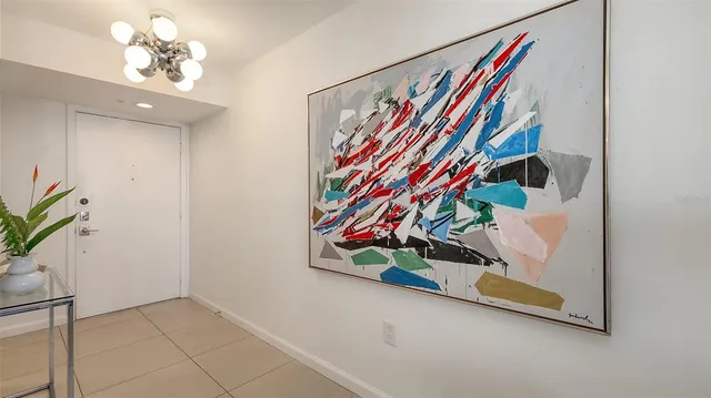 a living room with furniture a flat screen tv and floor to ceiling window