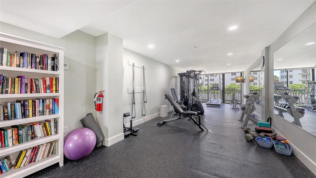 11 Sunset Drive, Unit 501 Sarasota, FL 34236 - Photo 53 of 63 a view of a room with gym equipment and floor to ceiling window