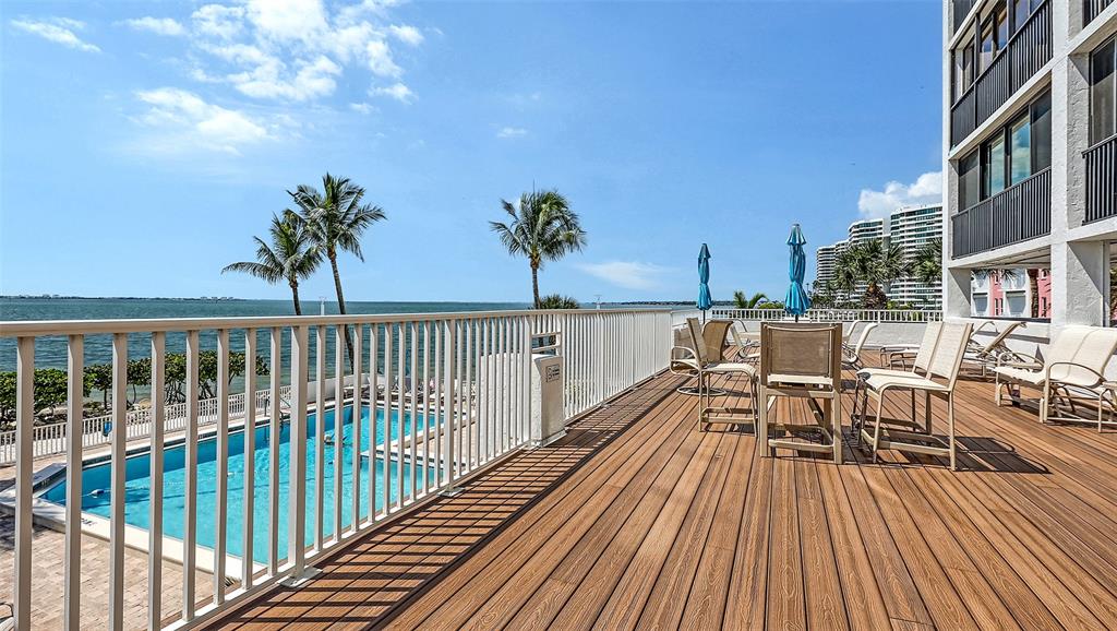 11 Sunset Drive, Unit 501 Sarasota, FL 34236 - Photo 57 of 63 a view of a balcony with chairs and wooden floor