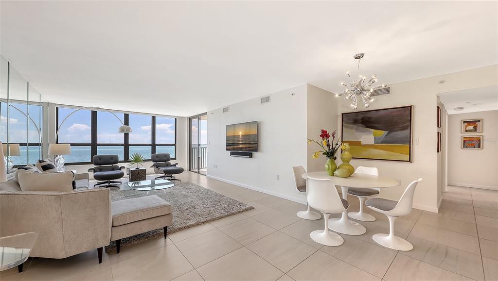 11 Sunset Drive, Unit 501 Sarasota, FL 34236 - Photo 6 of 63 a living room with furniture and a flat screen tv