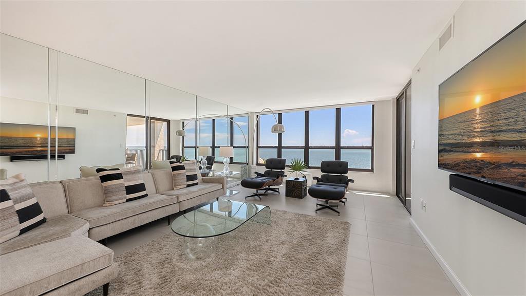 11 Sunset Drive, Unit 501 Sarasota, FL 34236 - Photo 9 of 63 a living room with furniture and a flat screen tv