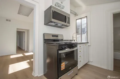 a kitchen with stainless steel appliances granite countertop a stove and a microwave
