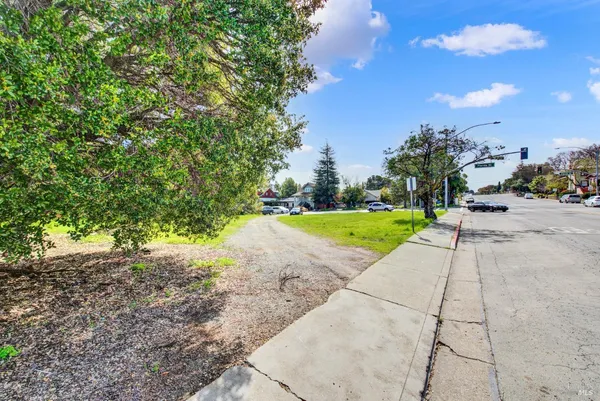 a view of a big yard with lots of green space