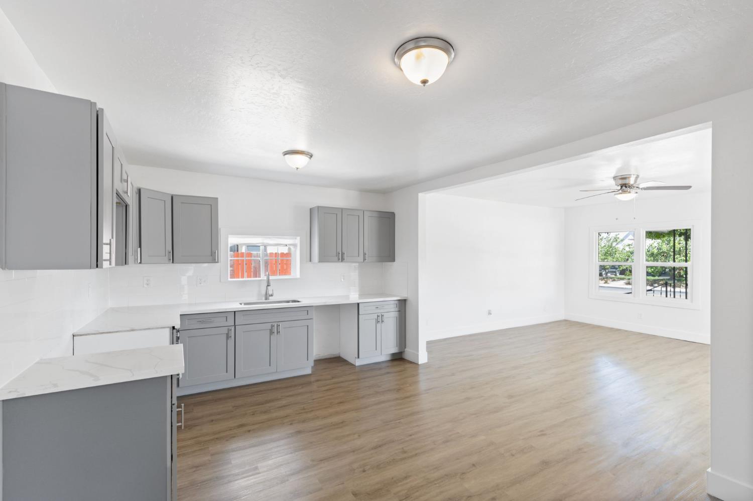 575 South 8th Street Kerman, CA 93630 - Photo 18 of 21 a view of kitchen with wooden floor and window