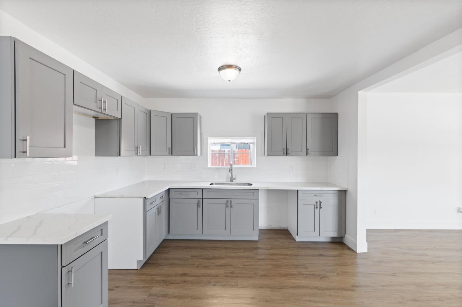 575 South 8th Street Kerman, CA 93630 - Photo 19 of 21 a kitchen with a sink and cabinets