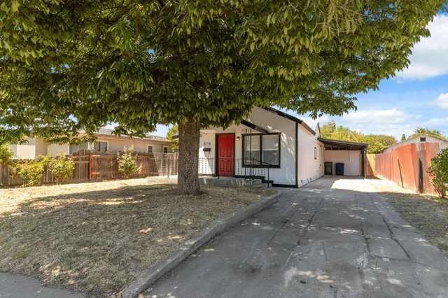 a view of a house with a tree