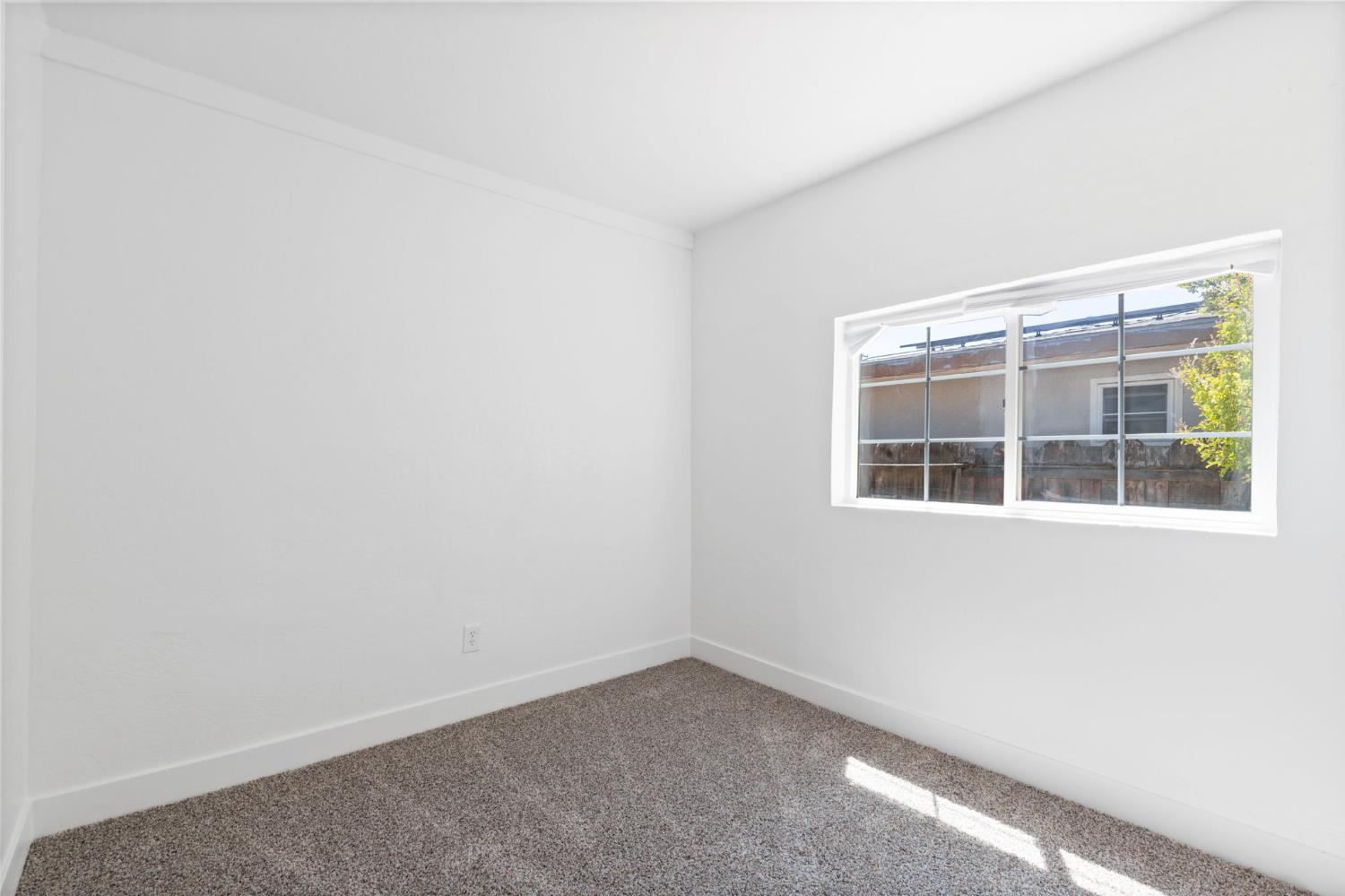 575 South 8th Street Kerman, CA 93630 - Photo 7 of 21 a view of an empty room with a window