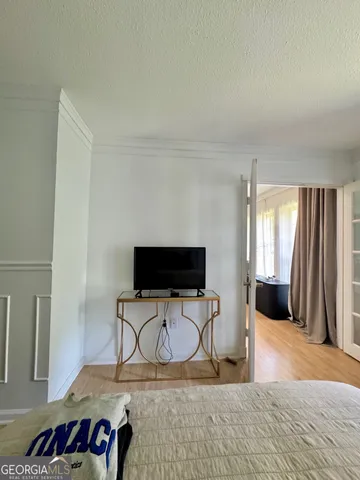 a view of a livingroom with workspace and a window