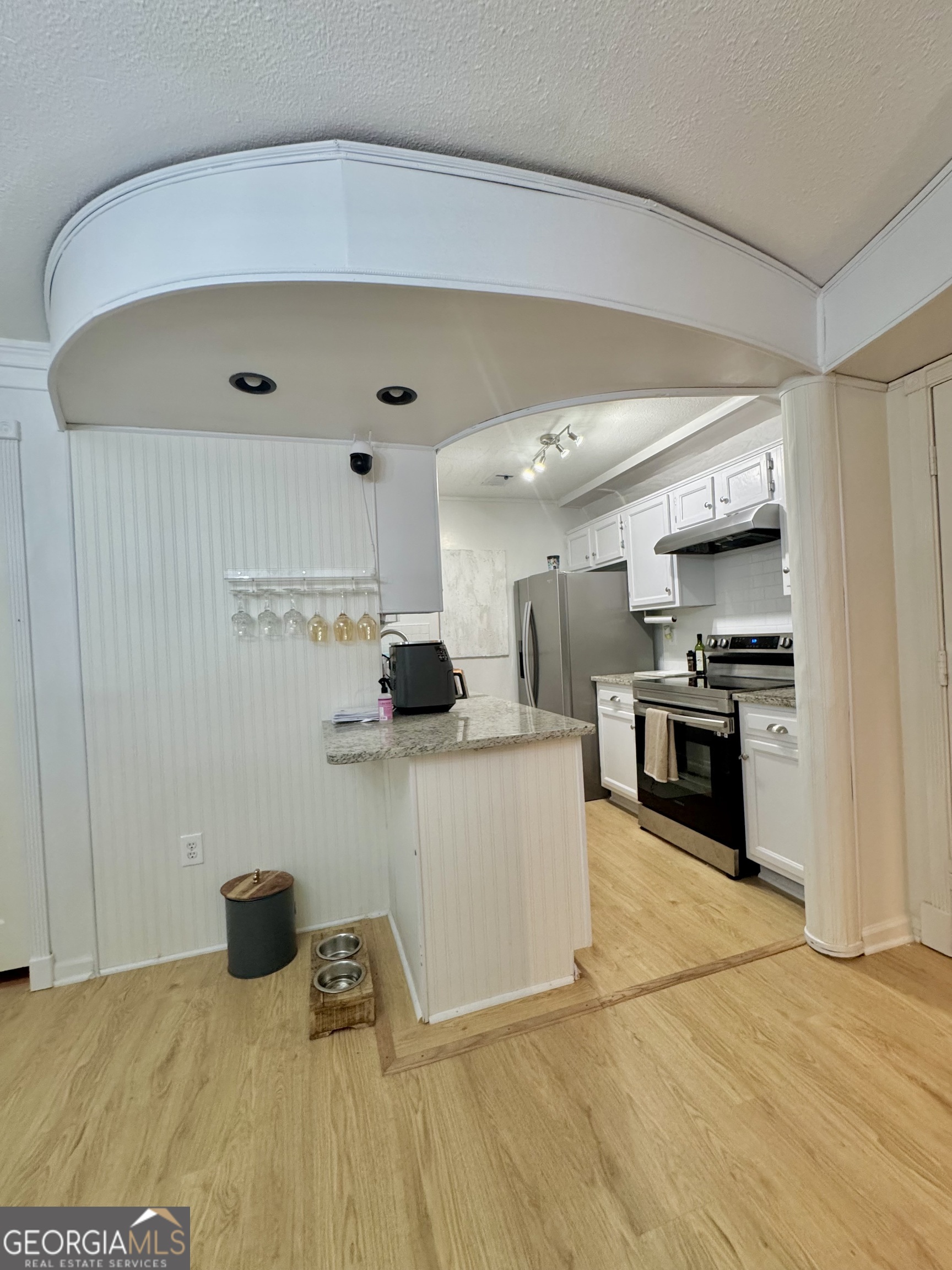 24311 Plantation Drive Northeast, Unit 311 Atlanta, GA 30324 - Photo 18 of 36 a kitchen with stainless steel appliances granite countertop a refrigerator and a stove top oven