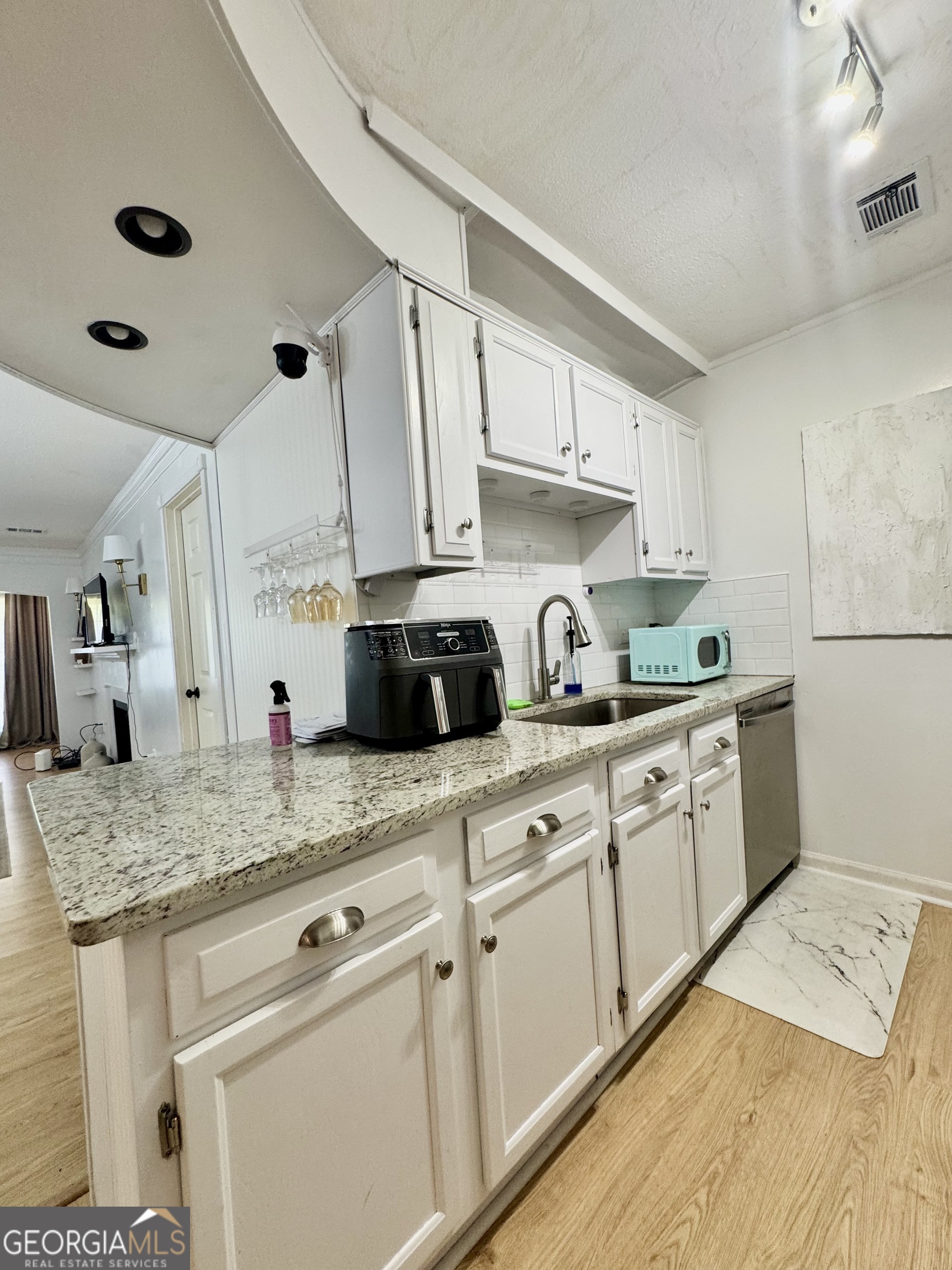 24311 Plantation Drive Northeast, Unit 311 Atlanta, GA 30324 - Photo 20 of 36 a kitchen with granite countertop a sink stainless steel appliances and cabinets