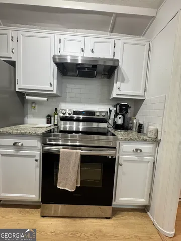 a kitchen with stainless steel appliances granite countertop a stove and a sink