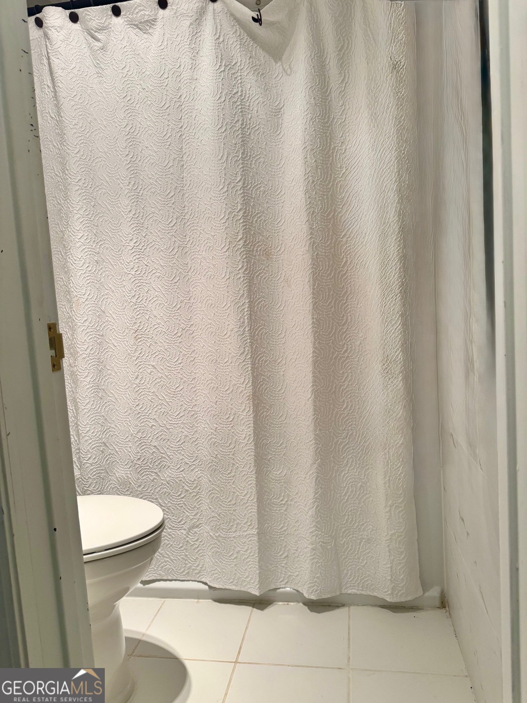 24311 Plantation Drive Northeast, Unit 311 Atlanta, GA 30324 - Photo 25 of 36 a white toilet sitting next to a shower