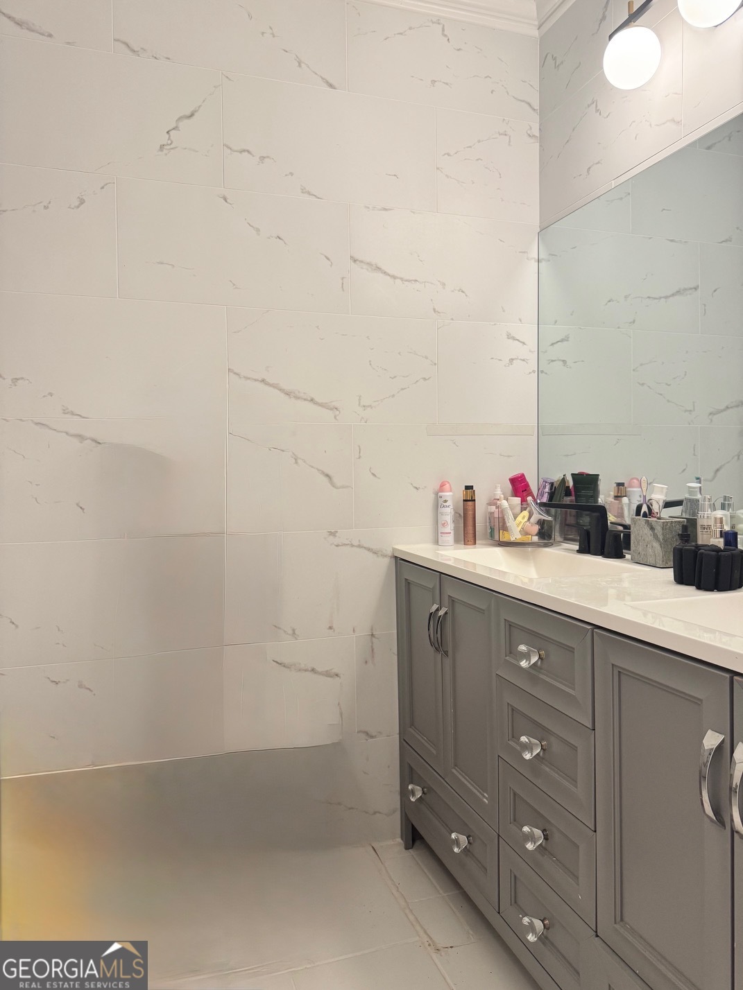 24311 Plantation Drive Northeast, Unit 311 Atlanta, GA 30324 - Photo 26 of 36 a bathroom with a sink and a mirror