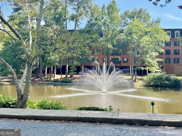 a view of swimming pool with outdoor seating and lake view