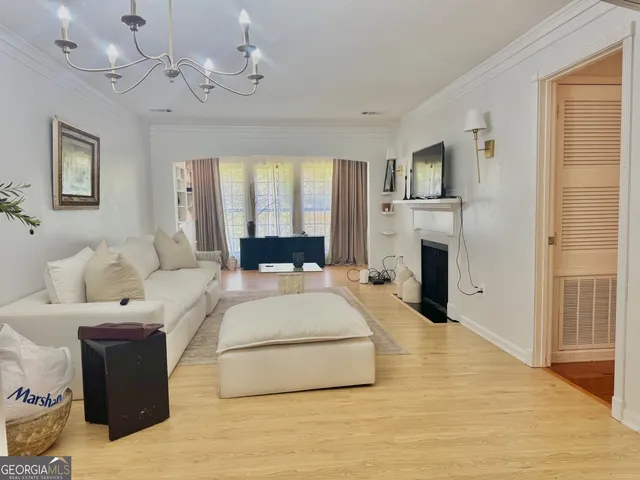 a spacious bedroom with a large bed and a chandelier