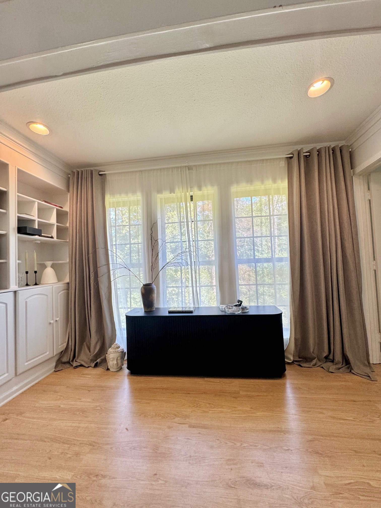 24311 Plantation Drive Northeast, Unit 311 Atlanta, GA 30324 - Photo 10 of 36 a view of a living room with a flat screen tv and floor to ceiling window