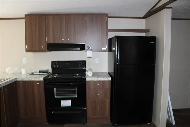 a kitchen with a sink a stove and refrigerator