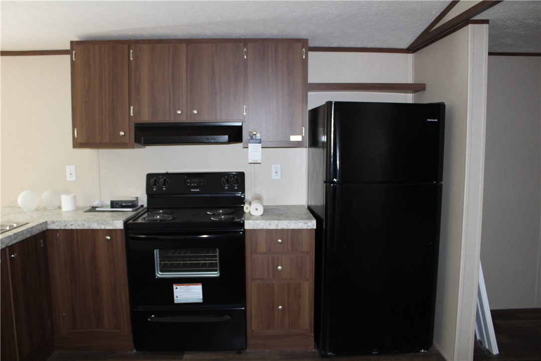 119 Royal Street Taylor, TX 76574 - Photo 12 of 18 a kitchen with a sink a stove and refrigerator