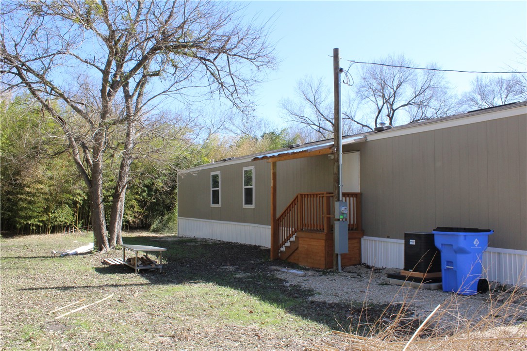 119 Royal Street Taylor, TX 76574 - Photo 14 of 18 a view of a barn in the middle of a yard