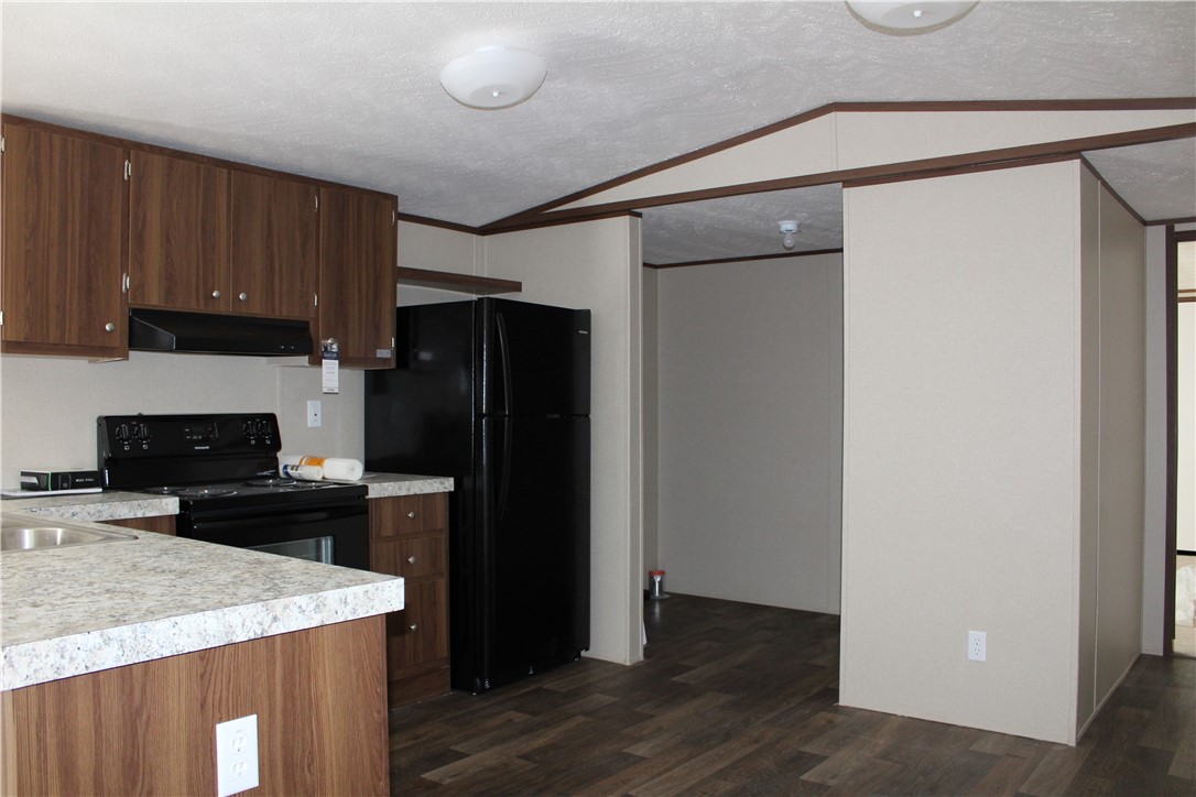 119 Royal Street Taylor, TX 76574 - Photo 8 of 18 a kitchen with a refrigerator a stove and a microwave
