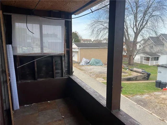 a view of balcony with floor to ceiling window and wooden floor