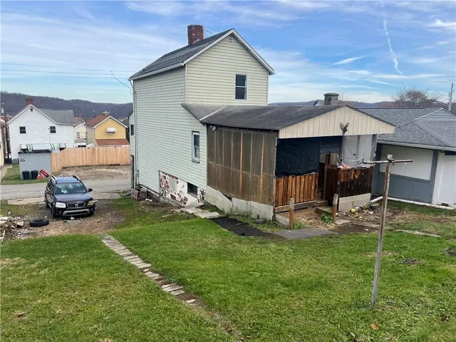 a front view of a house with a yard and porch