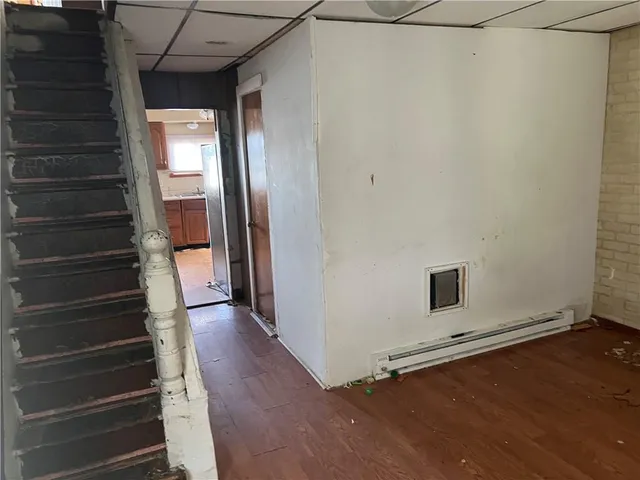 a view of a hallway with wooden floor and entryway