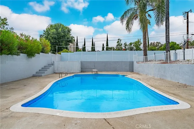 a view of a swimming pool with a terrace