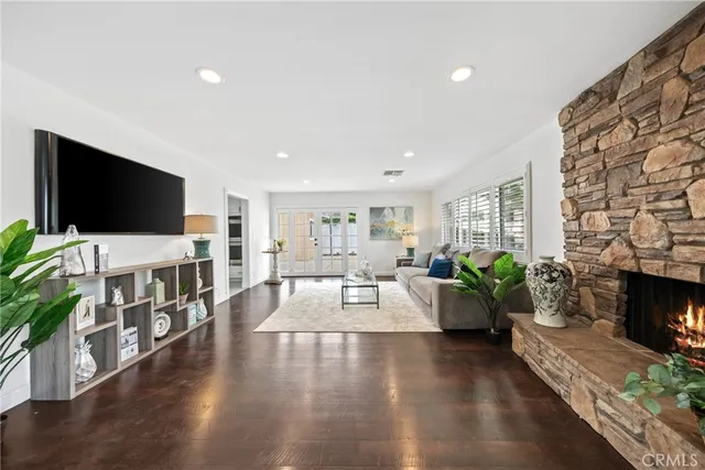 a living room with fireplace furniture and a flat screen tv