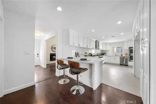 a kitchen with stainless steel appliances granite countertop a refrigerator and a stove top oven