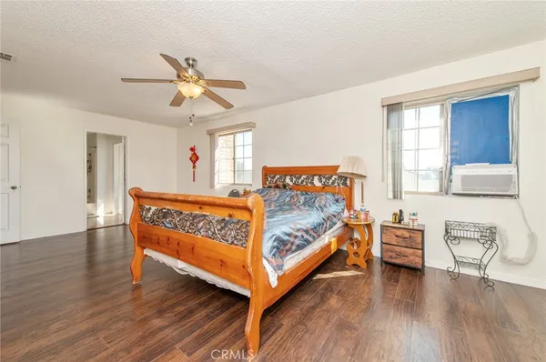 a bedroom with furniture and wooden floor