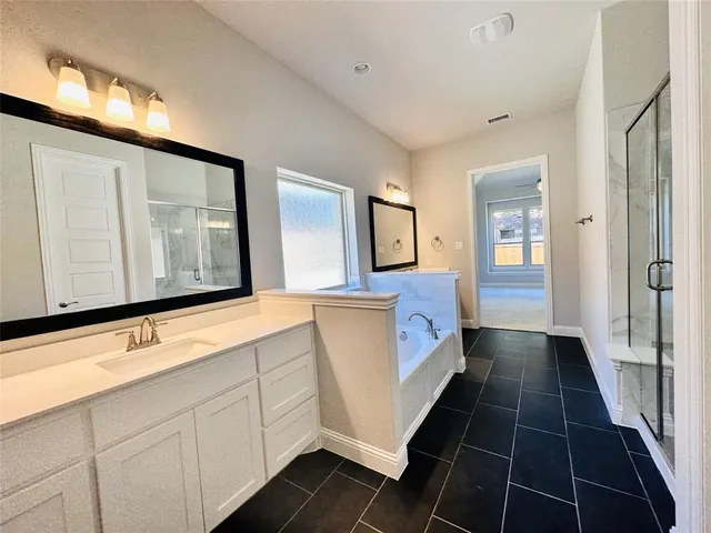 a bathroom with a glass shower door